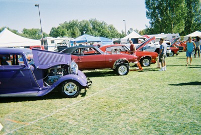 1972 Ford Ranchero - Cars are displayed on the grass at an outdoor event with tents and people milling around.