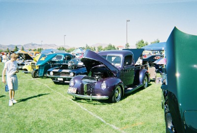 1972 Ford Ranchero - Several classic vehicles are displayed on a sunny day at an outdoor car show.