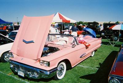1972 Ford Ranchero - A classic pink 1958 Ford Thunderbird convertible is displayed with its hood open at an outdoor car show.