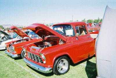 1972 Ford Ranchero - A row of classic trucks are displayed with their hoods open under a clear blue sky.