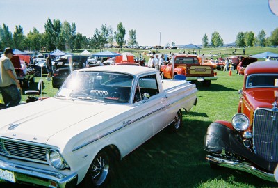 1972 Ford Ranchero - White 1965 Ford Ranchero pickup truck at an outdoor car show with other vehicles present.