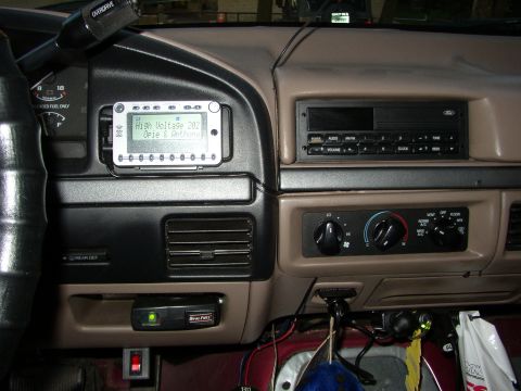 1995 Ford Bronco - Interior view of a 1992 Ford Bronco dashboard with various controls and an aftermarket device.
