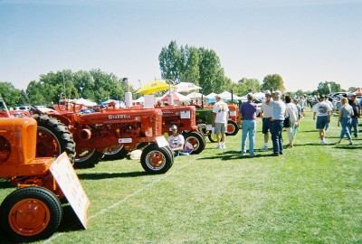 1972 Ford Ranchero - A sunny day at an outdoor event features a collection of vintage tractors on display for attendees to view.