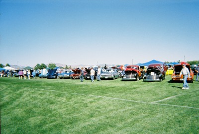 1972 Ford Ranchero - A sunny day at an outdoor car show features a variety of vehicles displayed on a green lawn.