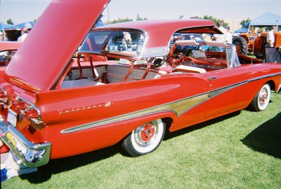 1972 Ford Ranchero - A red 1957 Ford Fairlane convertible is displayed with its hood and trunk open on a grassy field.