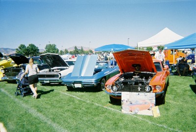 1972 Ford Ranchero - Several classic cars are displayed on a grassy field under a clear blue sky.