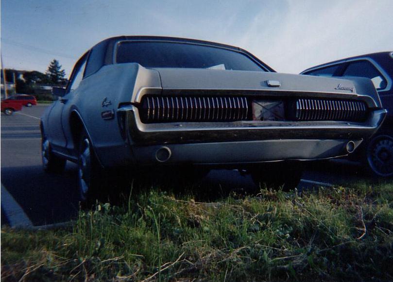 1968 Mercury Cougar, rear view, light blue, parked on grass