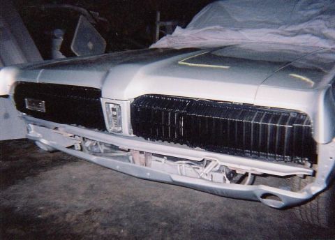 1968 Mercury Cougar - The front grille and bumper assembly of a Mercury Cougar, possibly undergoing restoration or repair.