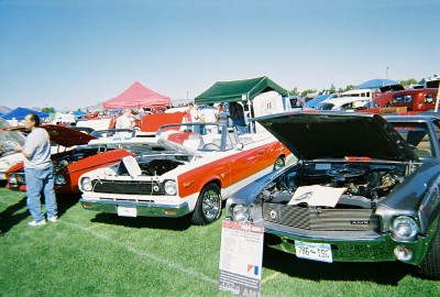 1972 Ford Ranchero - Several classic cars are displayed on a grassy field under a bright blue sky at an outdoor event.