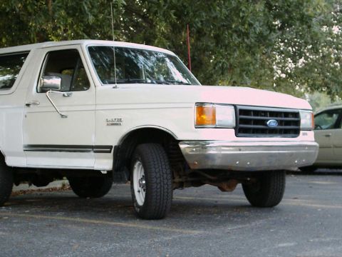 1988 Ford Bronco - This white 1988 Ford Bronco is shown from the front three-quarter view.