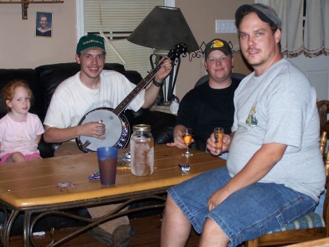 1979 Ford F-150 - A group of people are gathered indoors, with one man playing a banjo.