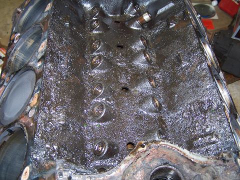 1979 Ford F-150 - Close-up view of an engine block's internal surfaces, heavily coated in oil.