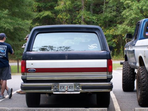 1979 Ford F-150 - Rear view of a Ford Bronco, parked next to another lifted truck.