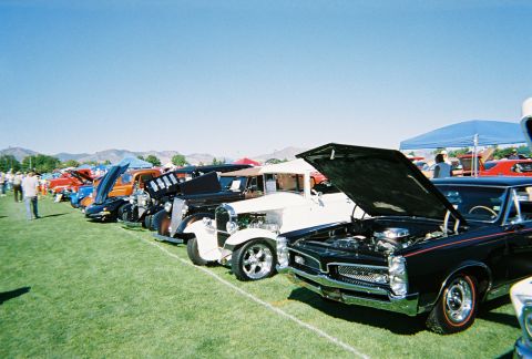 1972 Ford Ranchero - Cars on display at an outdoor event, with several vehicles showing their engines.