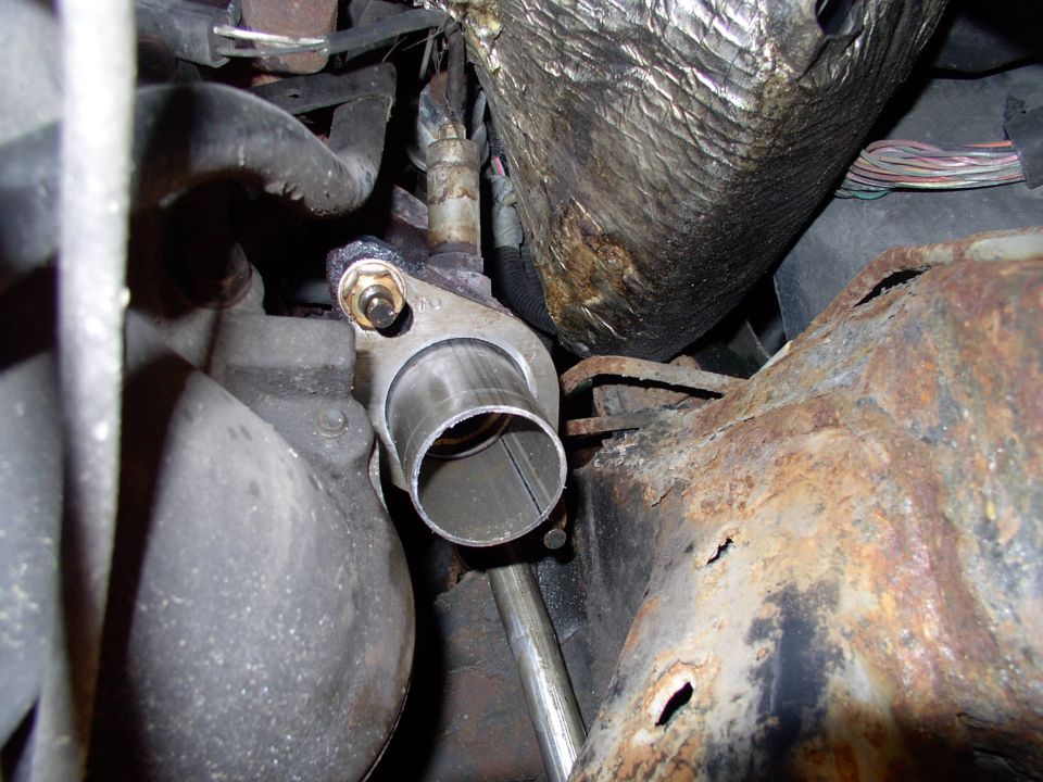 First he cut off the last 4" of the flared pipe, the part which is expanded to accept a 2" pipe. His reasoning was we could slip the 2 1/4" pipe right over the remaining stub of pipe.