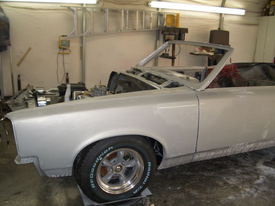 Silver 1967 Pontiac GTO convertible in a garage, primer finish, front quarter view, engine exposed