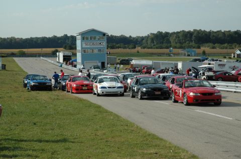 2000 Ford Mustang - Ford Mustangs gathered at Gingerman Raceway on a sunny day.