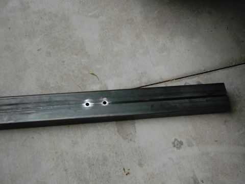 1978 Ford Bronco - A metal bar with two holes drilled into it rests on a concrete surface. The Supermotors.net logo is visible in the bottom right corner.