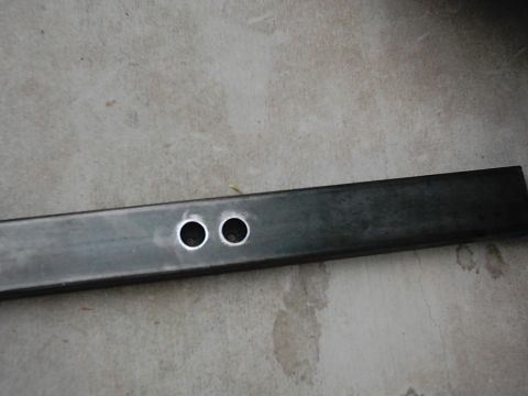 1978 Ford Bronco - Metal tube with two holes, likely a component for a project.
