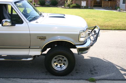 1994 Ford Bronco - Front 3/4 view of a two-tone 1994 Ford Bronco with an aftermarket bull bar.