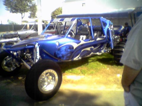 2005 BMW 3 Series - A custom blue dune buggy with flame graphics is parked outdoors.