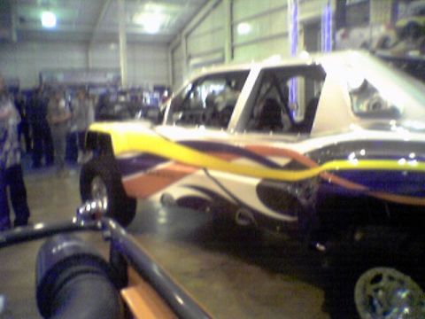 2005 BMW 3 Series - Customized pickup truck with racing stripes and visible roll cage.