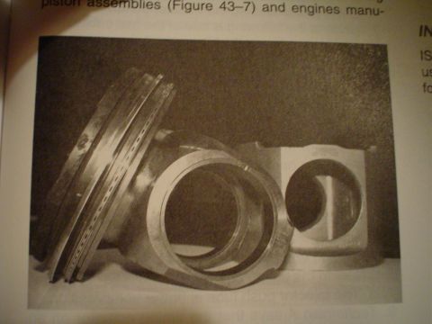 1966 International School Bus - This image displays engine components, likely pistons and sleeves, as depicted in a technical manual.