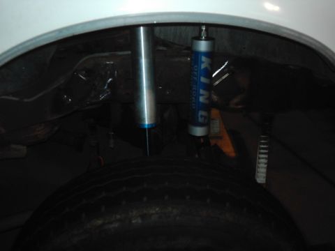 1978 Ford Bronco - The rear suspension of a vehicle is shown, a KING OFF ROAD shock absorber and a tire.