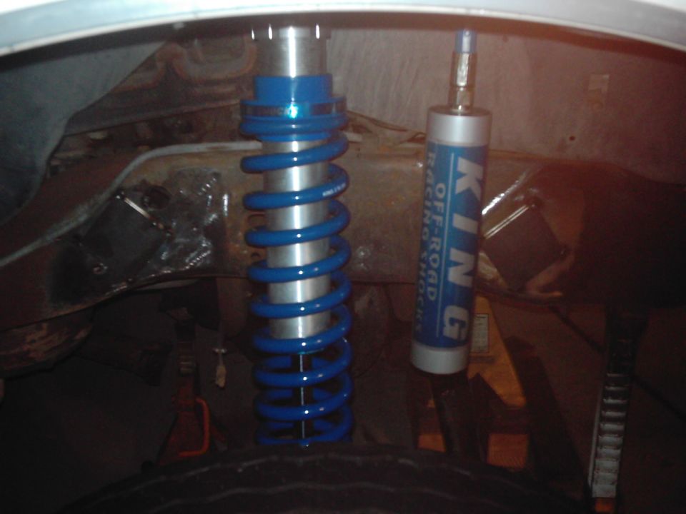 Blue King Off-Road Racing Shocks installed on a vehicle frame