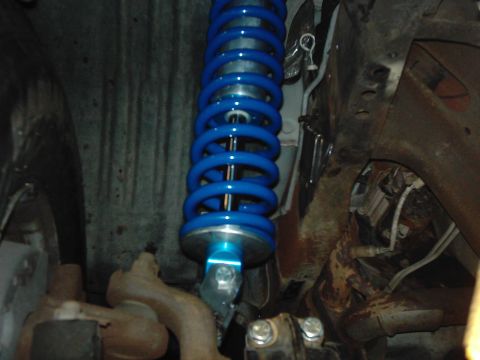 1978 Ford Bronco - Blue coilover shock absorber visible in the vehicle's suspension system.