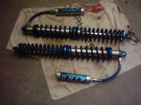 1978 Ford Bronco - Two King Off-Road shock absorbers with blue springs and silver bodies are laid out on a cloth.