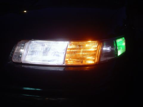 1993 Ford Taurus - Close-up of a car's front lighting assembly, showing the headlight, turn signal, and marker light.