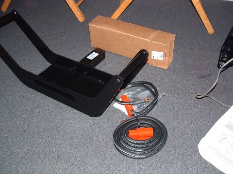 1993 Ford Bronco - A winch mount and associated wiring are laid out on a carpeted surface next to a cardboard box.
