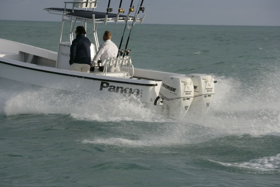 White Panga center-console boat with twin Evinrude 200 outboards running on open water