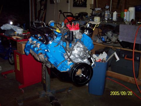 1985 Ford Bronco - Engine on a stand in a workshop, possibly undergoing a rebuild.