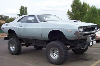 1995 Ford Bronco - This heavily modified 1970 Dodge Challenger features a significant lift kit and oversized tires, giving it a unique off-road stance.