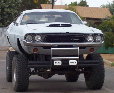 1995 Ford Bronco - Custom 1970 Dodge Challenger body mounted on a monster truck chassis with oversized wheels.