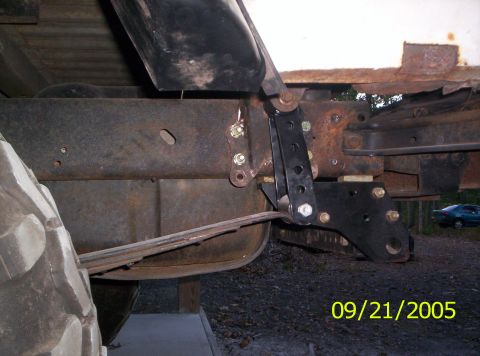 1985 Ford Bronco - This photo shows the underside of a vehicle, focusing on the suspension system and frame components.