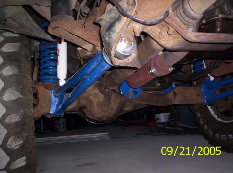 1985 Ford Bronco - This photo shows the undercarriage of a vehicle, focusing on suspension and drivetrain components.
