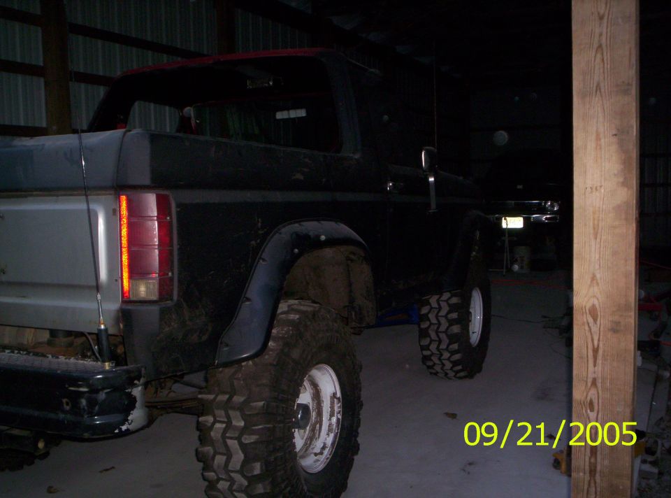 Rear view of black Ford Bronco with lifted suspension and large tires