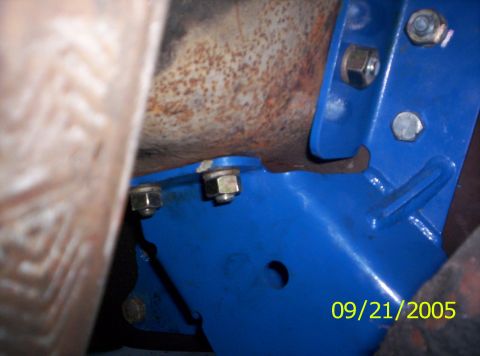 1985 Ford Bronco - Close-up of a blue suspension component bolted to rusty metal, with a date stamp of 09/21/2005 visible.