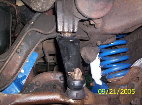 1985 Ford Bronco - Undercarriage view of suspension parts, including blue springs and tie rod ends.