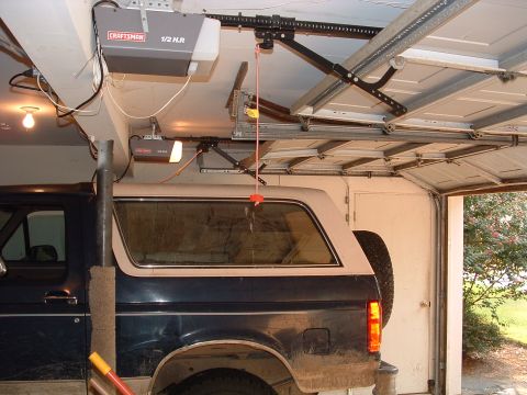 1993 Ford Bronco - The side profile of a 1993 Ford Bronco, showing its two-tone paint scheme and spare tire mounted on the rear.