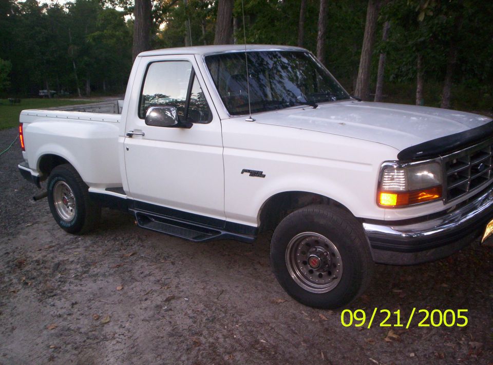 White Ford F-150 pickup truck parked outdoors