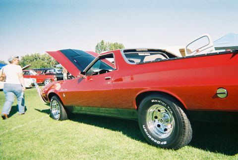 1972 Ford Ranchero - A red 1972 Ford Ranchero is displayed with its hood open at an outdoor car show.