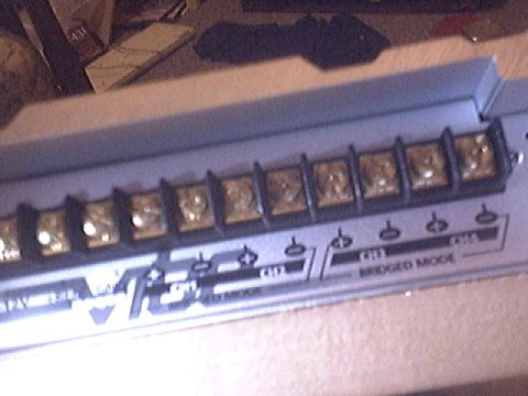 1994 Ford Probe - Audio amplifier terminal block showing speaker connections and mode selection.