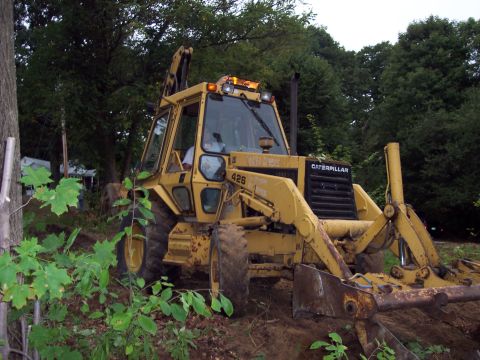 2001 Ford Crown Victoria - Caterpillar 426 backhoe loader on a construction site.