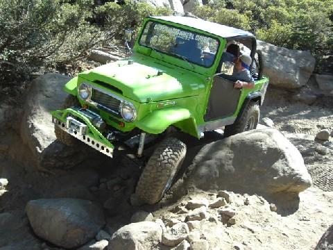 1996 Ford Bronco - This off-road vehicle is shown navigating a challenging rocky terrain, demonstrating its off-road capabilities.
