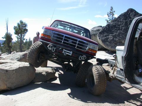 1996 Ford Bronco - This 1996 Ford Bronco is shown off-roading over large rocks, demonstrating its capability.