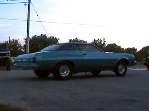 1977 Ford F-150 - Side view of a teal 1977 Ford Gran Torino coupe with aftermarket wheels.